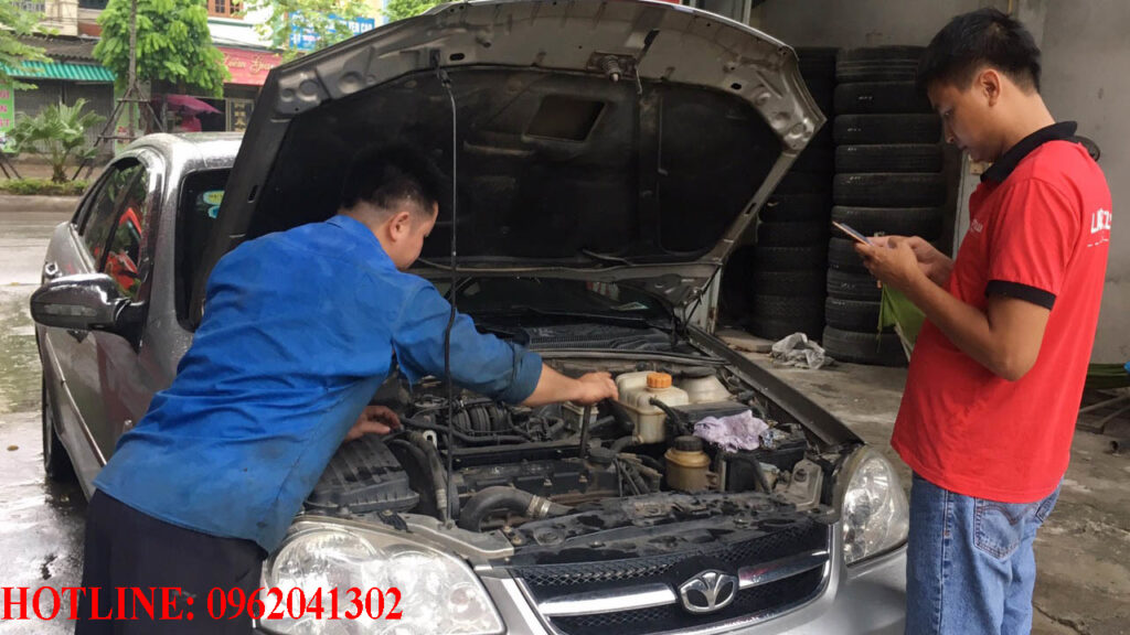 Thợ sửa xe ô tô chuyên nghiệp đang kiểm tra động cơ tại Thường Tín